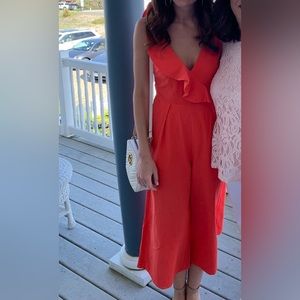 Bright coral/red jumpsuit with ruffle